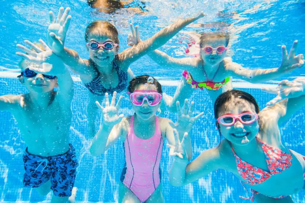 - Blue Lagoon Pool Management - Blue Lagoon Pool Management Children swimming in a clean, clear backyard pool serviced by Blue Lagoon Pool Management in Gilbert, AZ