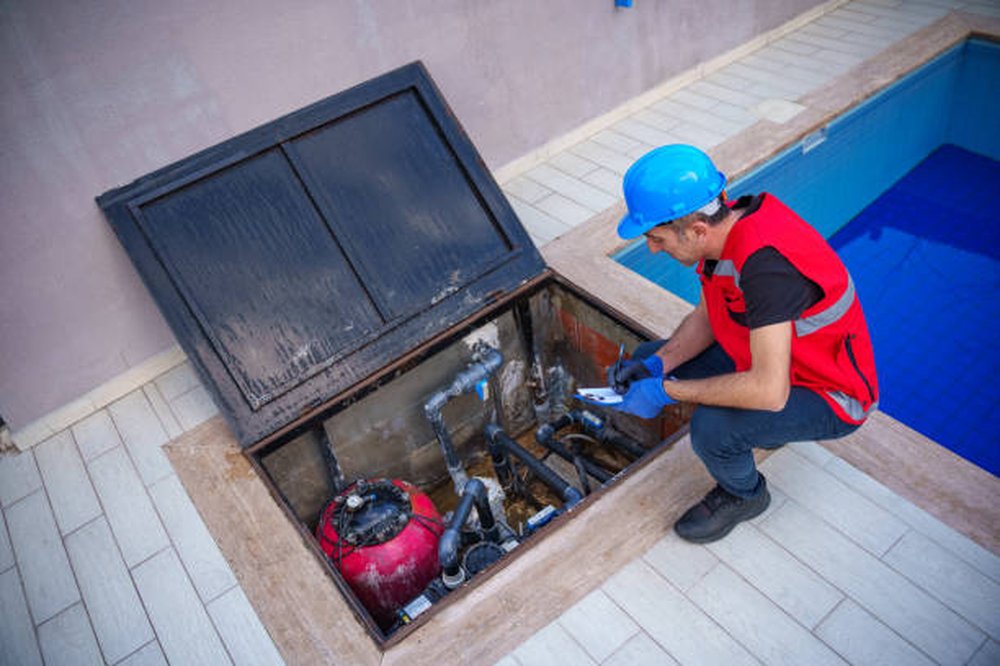 Blue Lagoon technician repairing pool equipment at the pad in Mesa, AZ