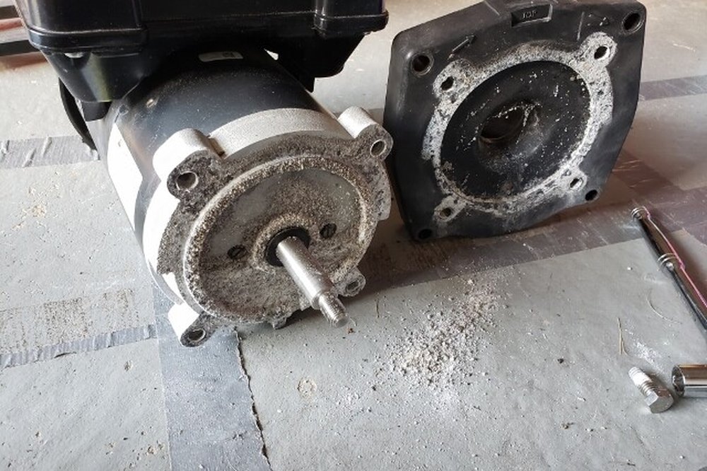 Corroded, failing pool pump motor removed for repair in Mesa, AZ