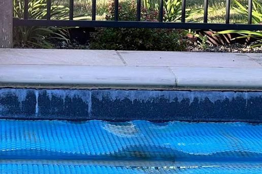 White calcium scale on a pool waterline tile in Chandler, AZ