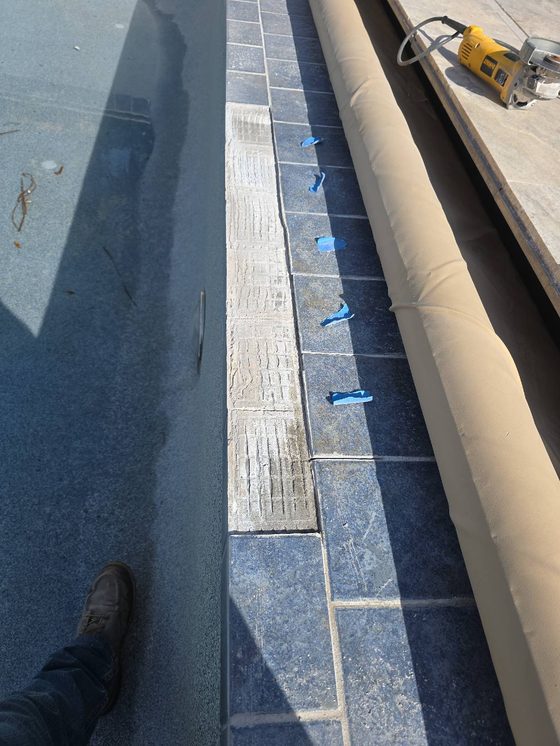 Worn, failing waterline tile on an older pool that needs a remodel in Tempe, AZ