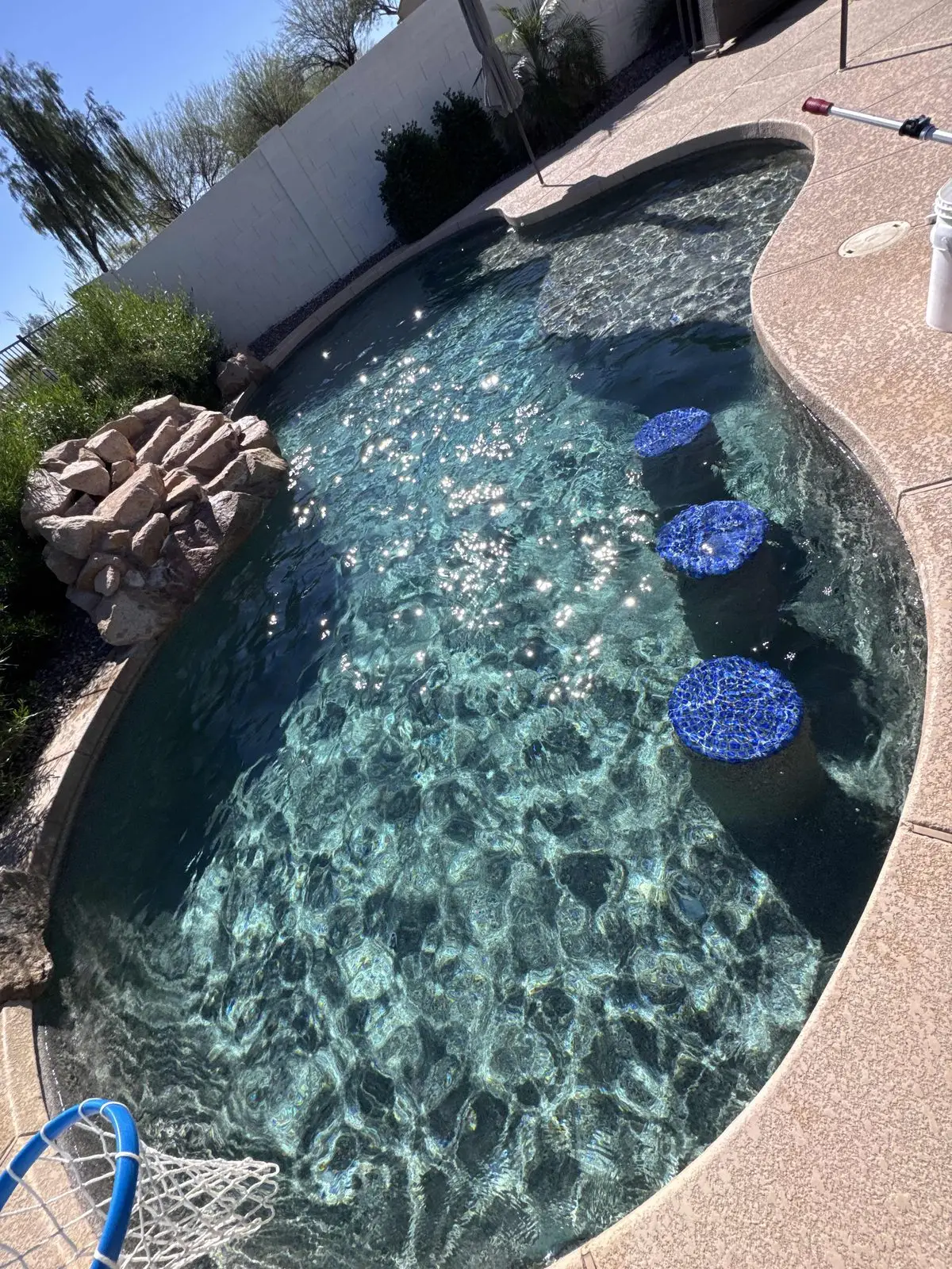 Remodeled pool with a pebble finish and tiled bar stools in Gilbert, AZ