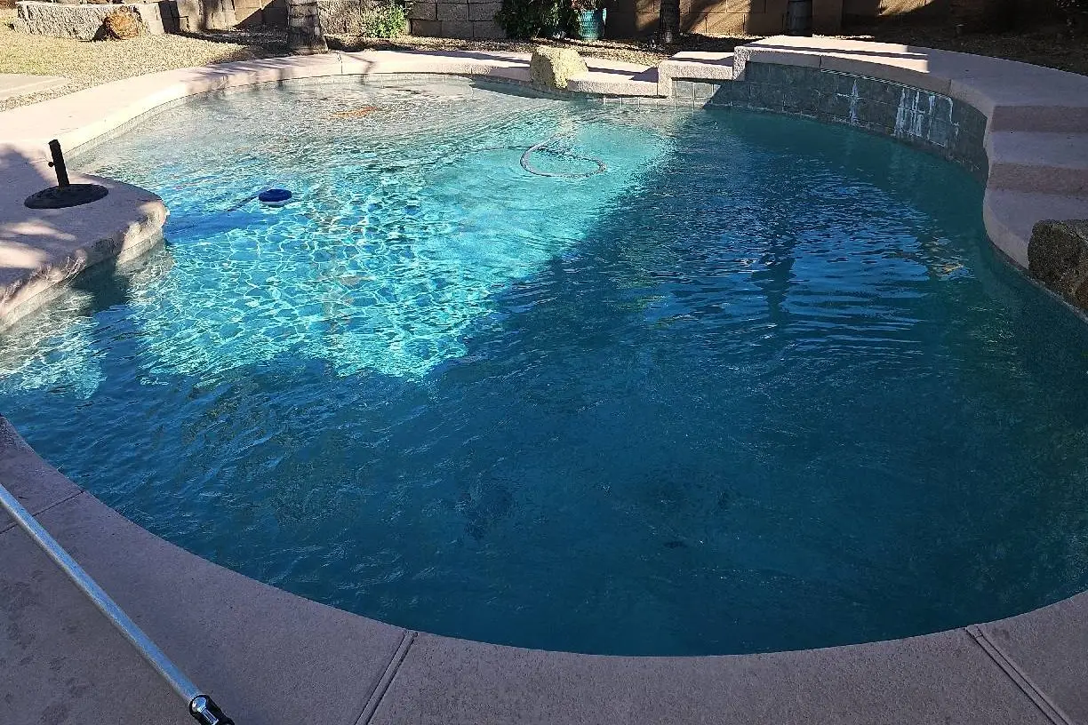 Remodeled backyard pool with a new interior finish in Tempe, AZ